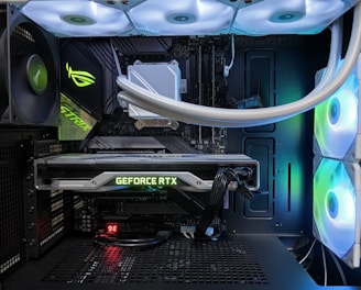 A high-end gaming or performance PC interior equipped with RGB lighting and multiple cooling fans. The graphics card prominently displayed is a GeForce RTX model, with branding visible. The setup includes neatly managed cables and a liquid cooling system.